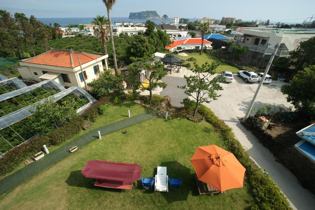 an overhead view of a yard with an orange umbrella at Galeum Guesthouse in Seogwipo
