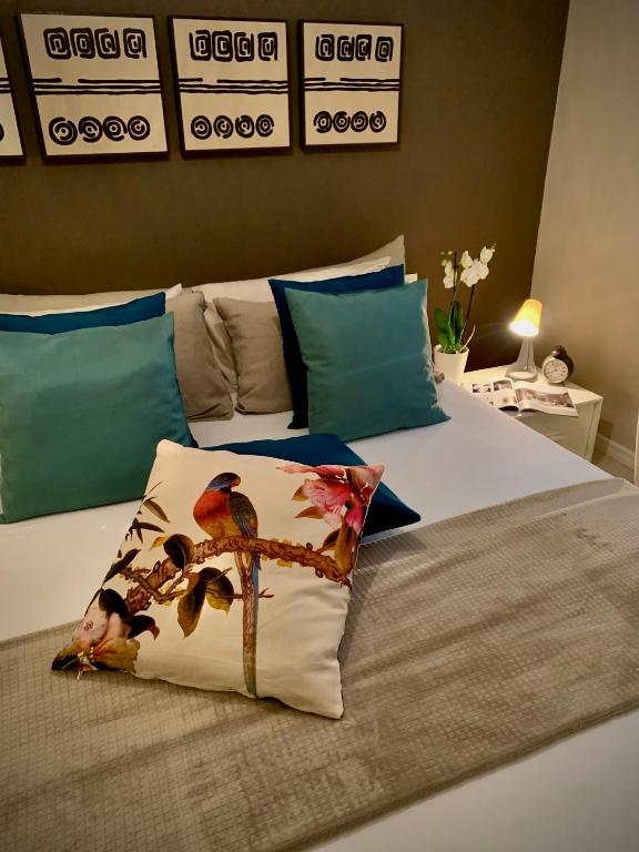 a bed with a pillow with birds on it at Villa Luminosa in Torre del Lago Puccini