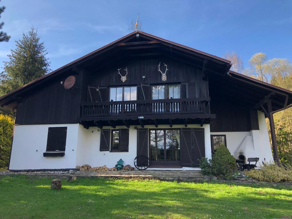 a large black and white house with a balcony at Dom alpejski Krośniczanka in Krośnica