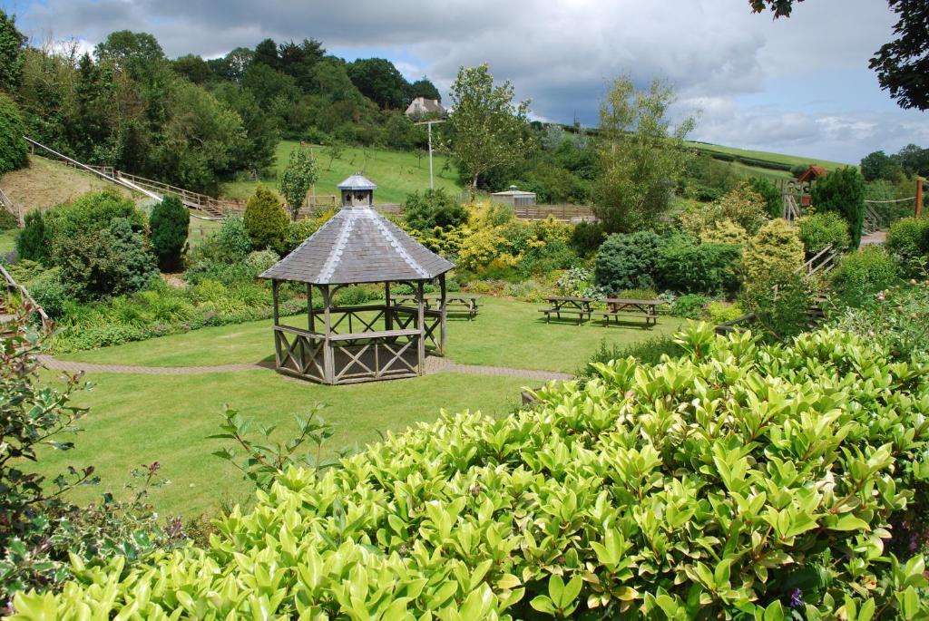 a gazebo in the middle of a garden at The Waie Inn in Copplestone