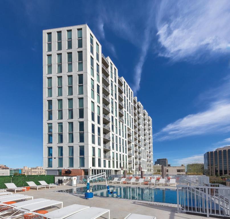 a tall white building with a pool in front of it at Club Wyndham Austin in Austin