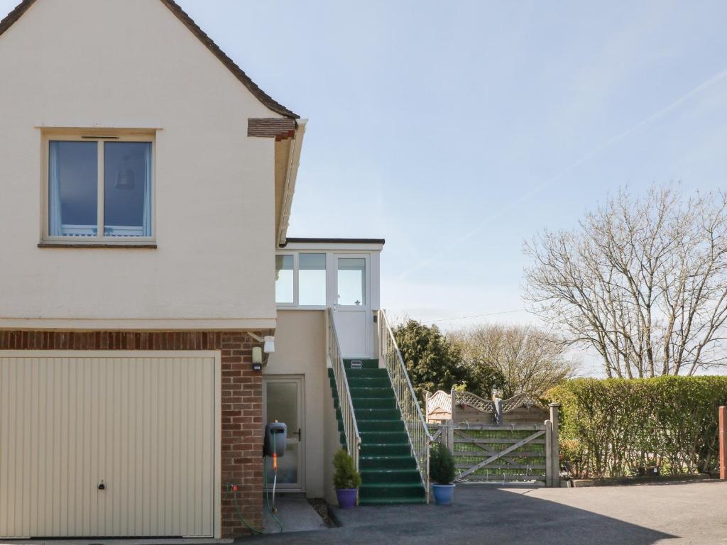 a house with a staircase leading to a garage at Northlands Studio in Plymouth