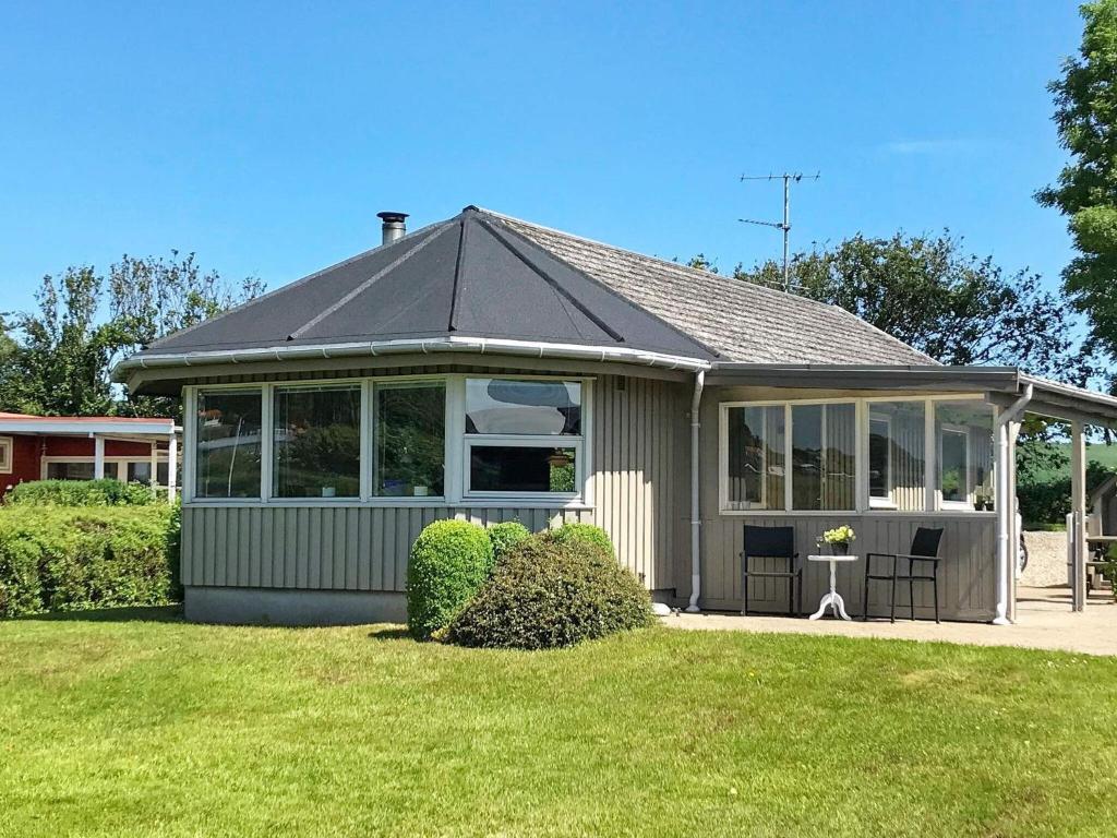 a house with a conservatory with a lawn at Two-Bedroom Holiday home in Aabenraa 2 in Aabenraa