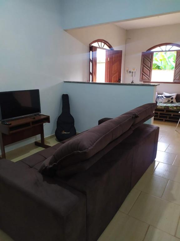 sala de estar con sofá y TV en Casa Caparaó, en Caparaó Velho