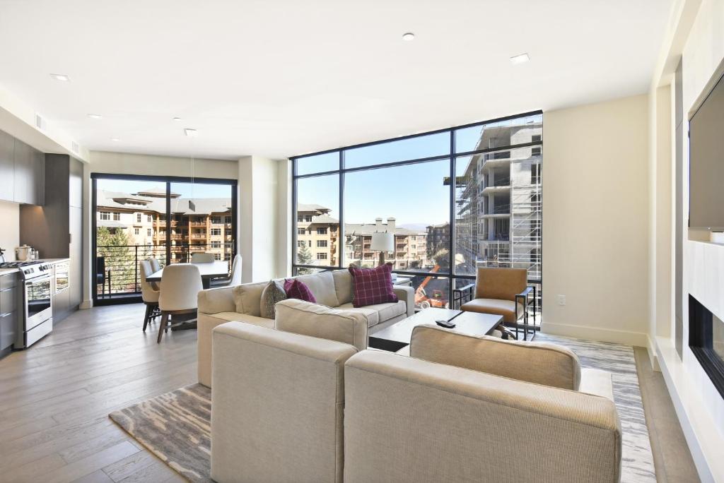 a living room with a couch and chairs and a fireplace at Luxury 2 BR in Canyons Village - Walk to Slopes in Park City