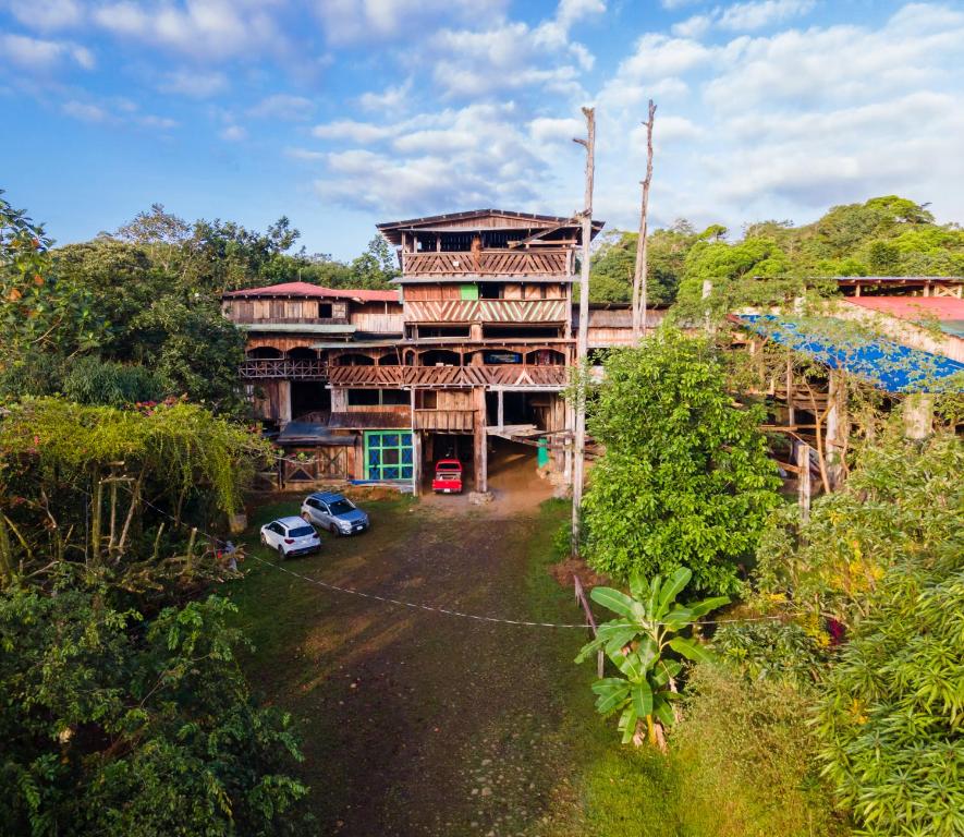 an aerial view of a building with cars parked in front at Mirador Prendas in Sarapiquí