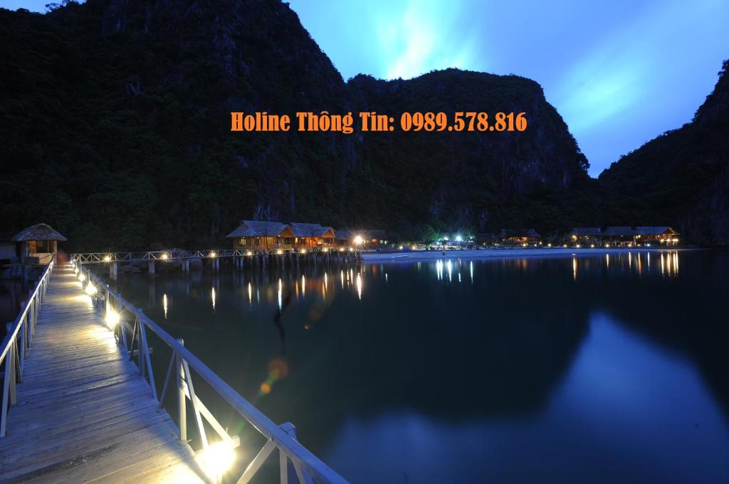 
a scenic view of a lake with a bridge over it at Cat Ba Sandy Beach Resort in Cat Ba
