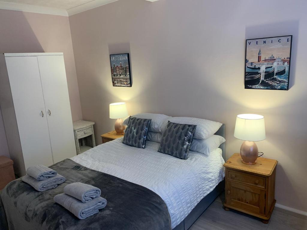 a bedroom with a bed with two pillows on it at Eastbourne Town centre Maisonette apartment in Eastbourne