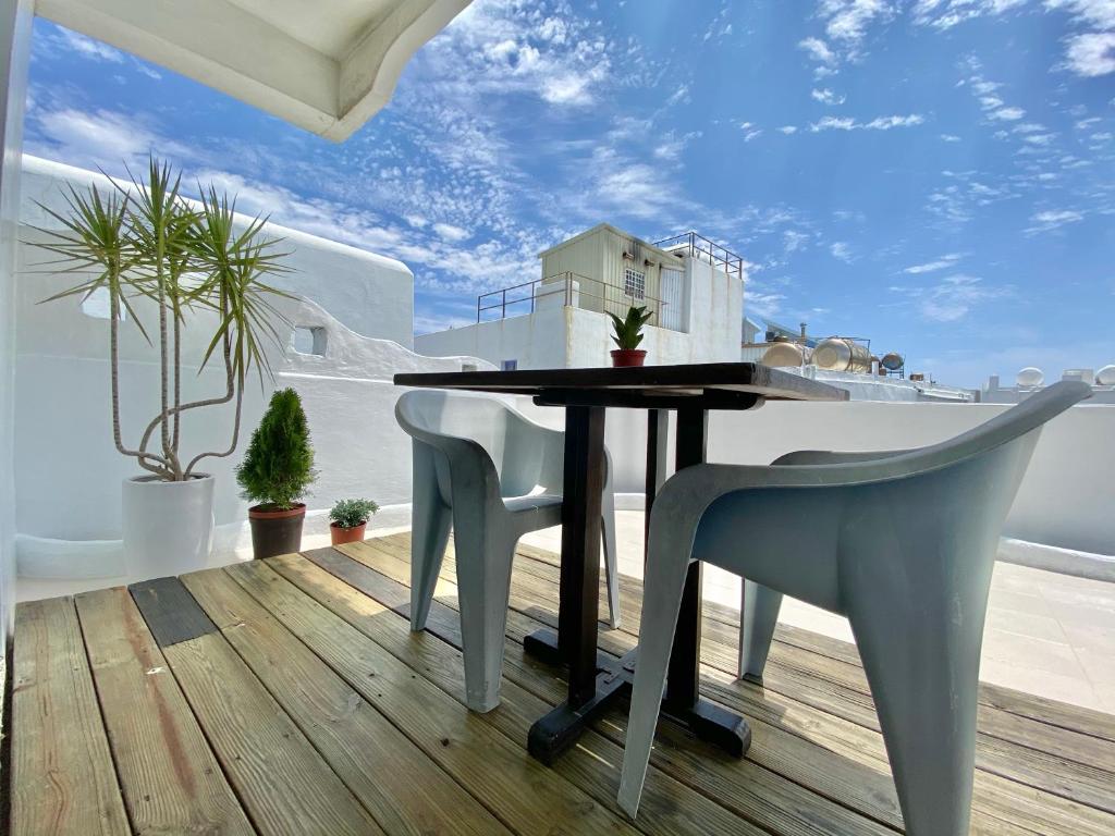 a dining room with a table and chairs on a deck at Blue Sea Inn in Eluan