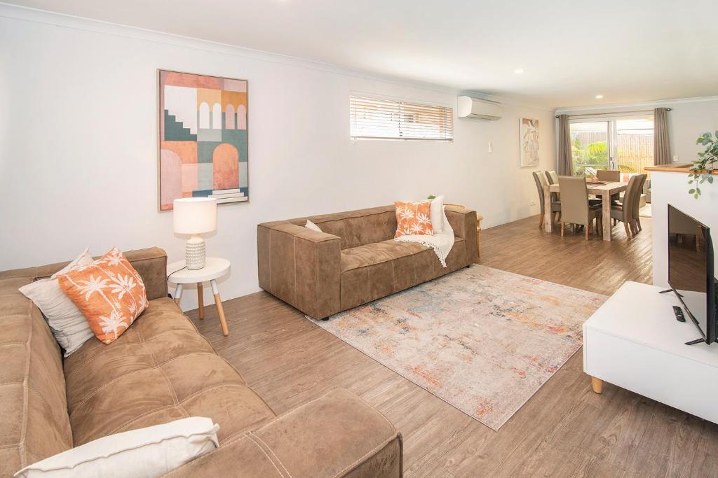 a living room with a couch and a table at Central Townhouse Margaret River in Margaret River Town