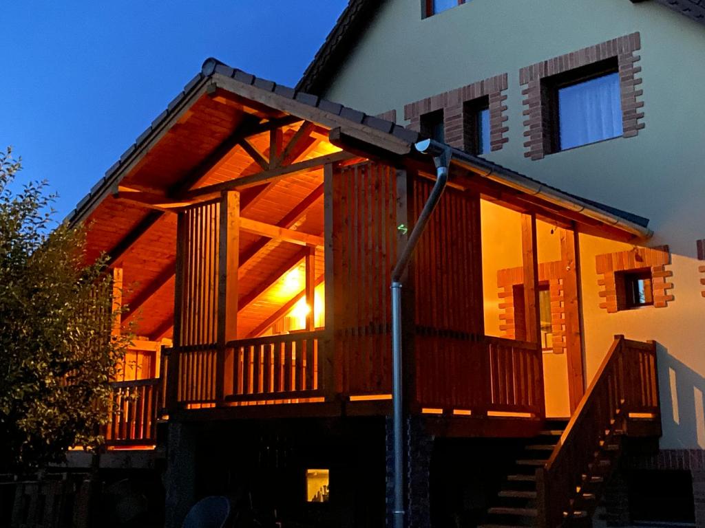 a log cabin with a staircase leading up to it at Grádics Panzió in Siculeni