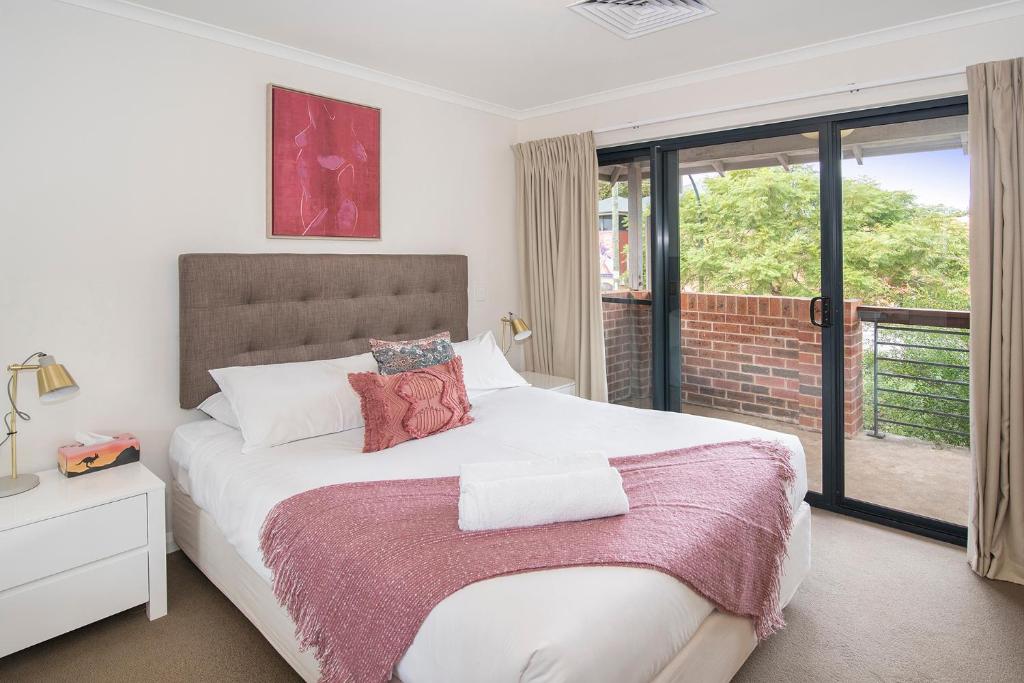 a bedroom with a large bed and a window at Apartment 36 in Margaret River Town