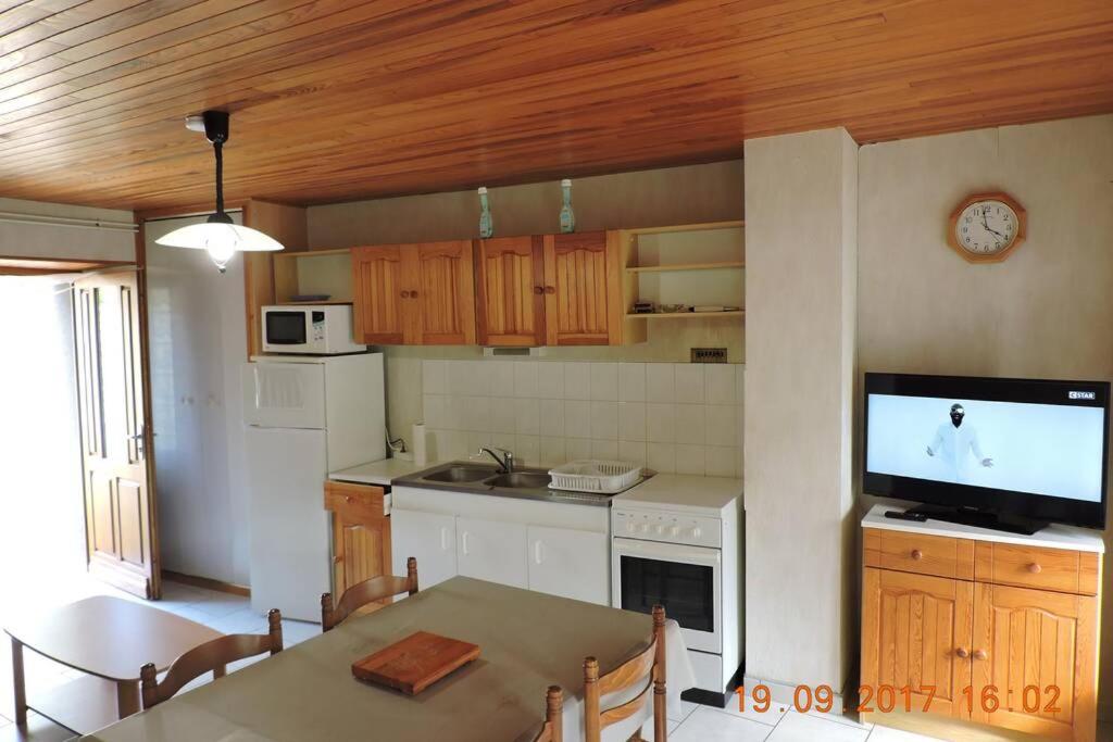 a kitchen with a table and a television in it at Gite au pied du mont Lozère 2 in Mas-dʼOrcières