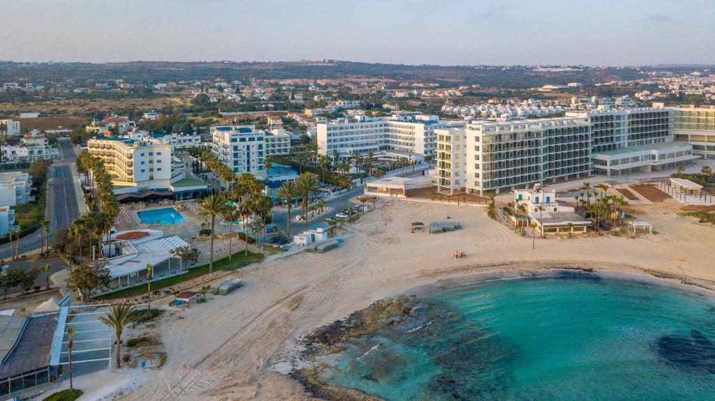 an aerial view of a beach and buildings at Anonymous Beach Hotel (Adults 16+) in Ayia Napa