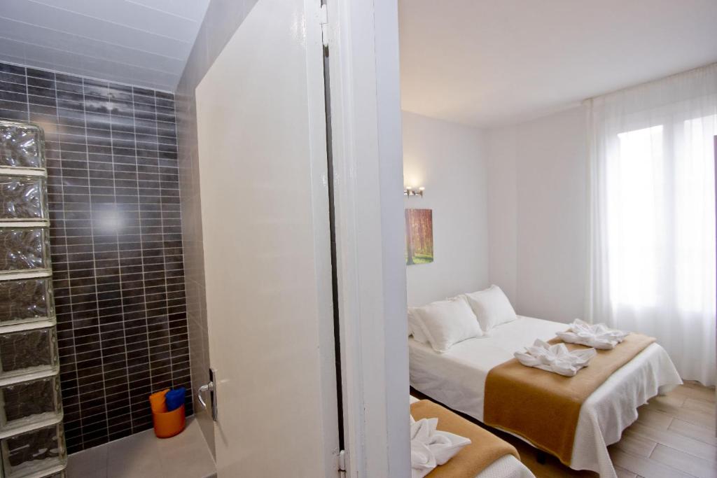 Posteľ alebo postele v izbe v ubytovaní Barcelona City Hotel