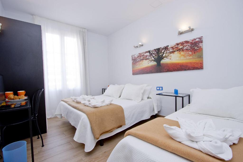 Posteľ alebo postele v izbe v ubytovaní Barcelona City Hotel