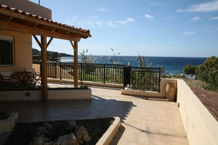 a house with a patio with a view of the ocean at Akti Damnoni in Damnoni