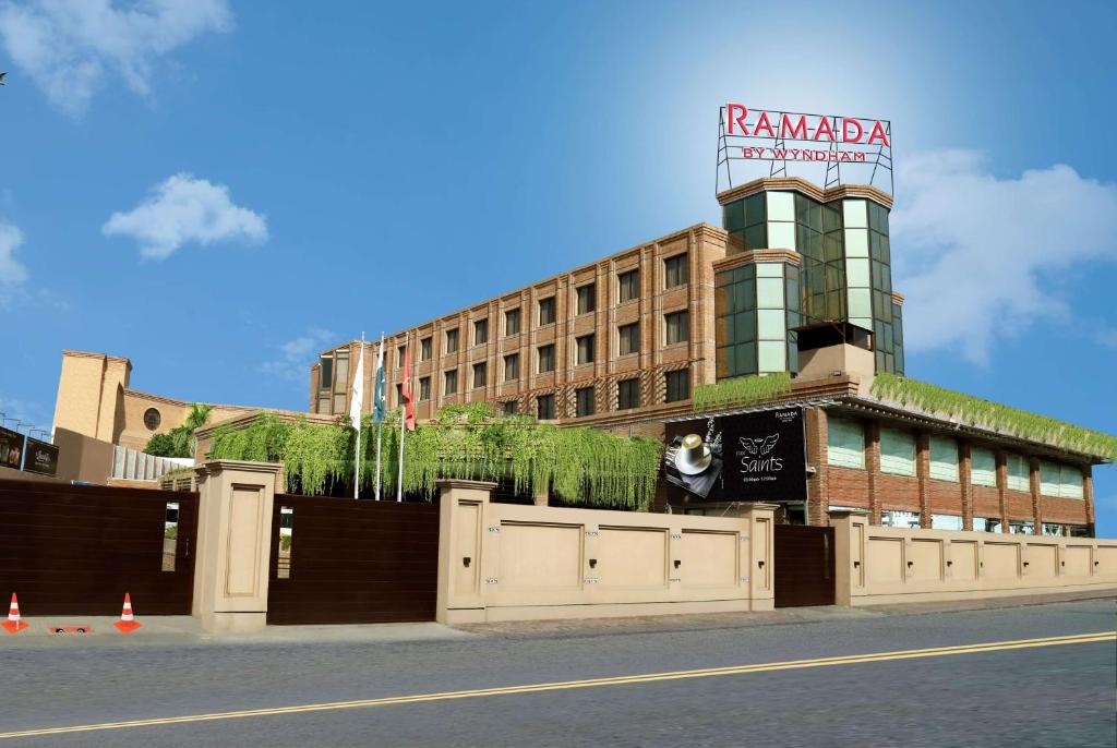 a building with a sign on top of it at Ramada by Wyndham Multan in Multan