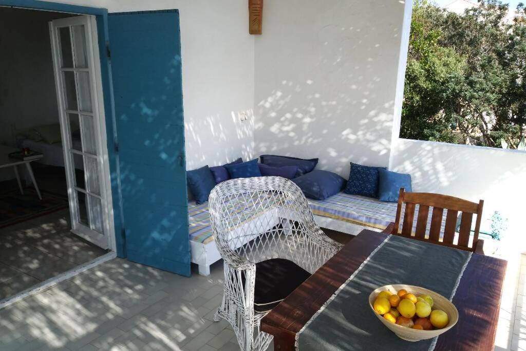 a table with a bowl of fruit on a patio at Getaway house Gundula in Podstražje