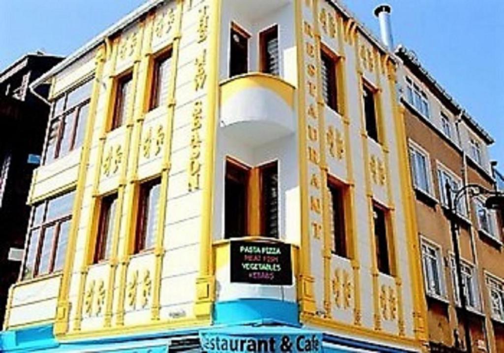 a yellow and white building with a sign in front of it at The New Season Apart in Istanbul