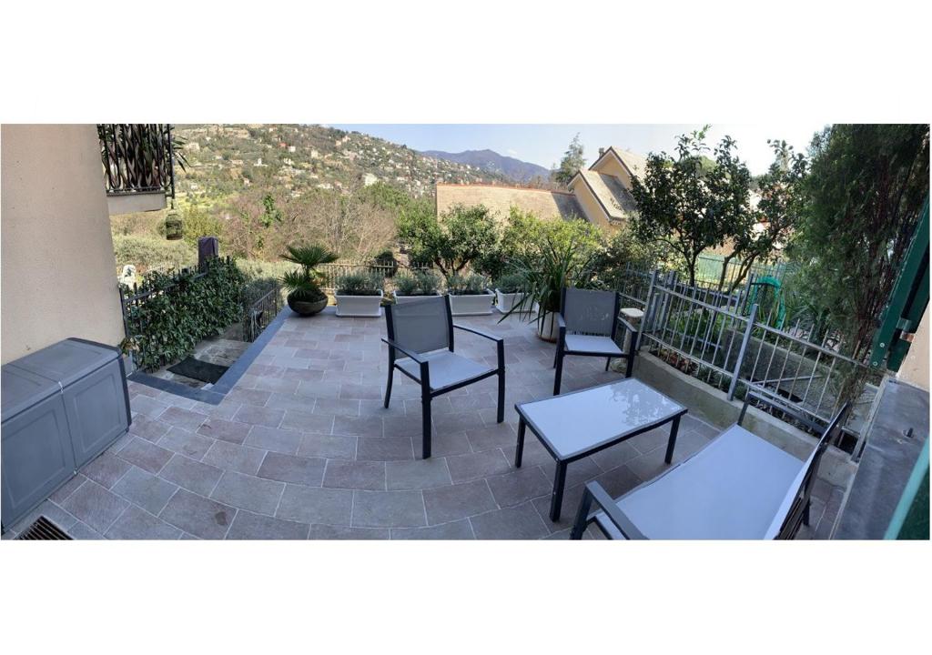 a patio with tables and chairs on a patio at Relax nel Tigullio in Santa Margherita Ligure