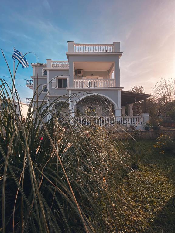a large white house on top of a hill at Thèros Mansion 5BR Mansion Sky Villa 360 Views, Infinity Pool & Jacuzzi Spa in Planos