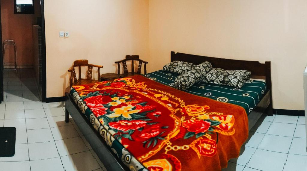 Postel nebo postele na pokoji v ubytování Hotel Gunung Mas Syariah