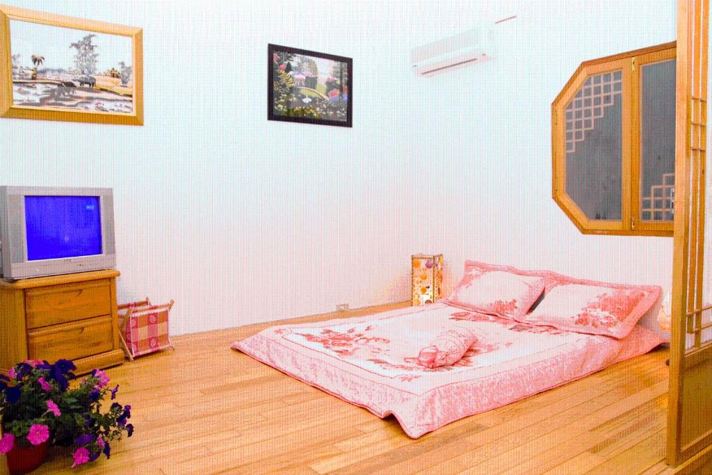 Postel nebo postele na pokoji v ubytování Yilan Xiang Feng Homestay