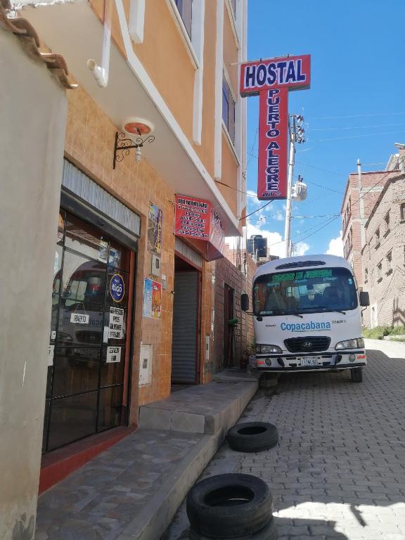 a white van parked outside of a building at Hostal Puerto Alegre in Copacabana