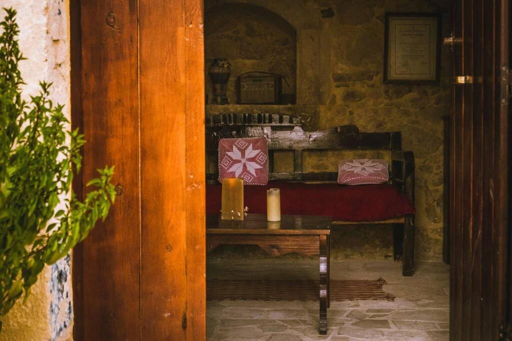 a room with a table with a bed in it at The Royal Stonehouse : Sophia in Vasilikí