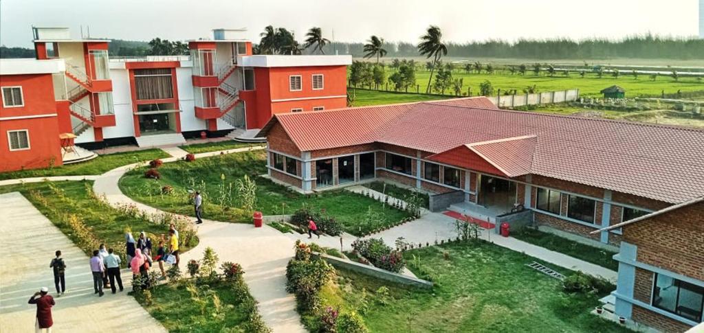a group of people standing in front of a building at Marina Beach Villas Resort in Cox's Bazar