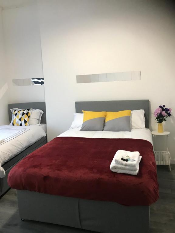 a bedroom with a large bed with a red blanket at Norton Road in Stockton-on-Tees