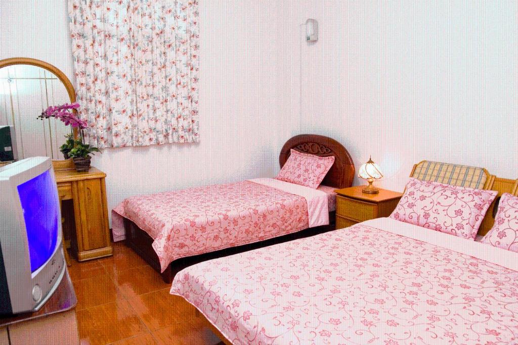 Postel nebo postele na pokoji v ubytování Yilan Xiang Feng Homestay