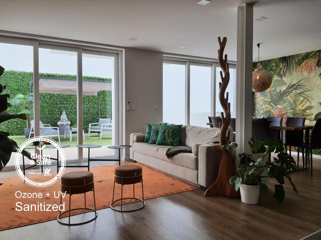 sala de estar con sofá, mesa y sillas en Exotic Fusion double Suite with Garden, en Lisboa