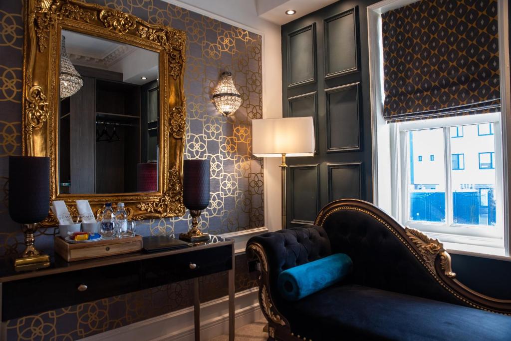 a living room with a chair and a mirror at Domo Boutique Hotel in Oldbury