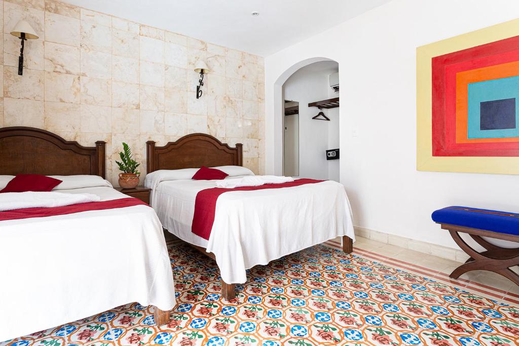 Postel nebo postele na pokoji v ubytování La Aurora Hotel Colonial