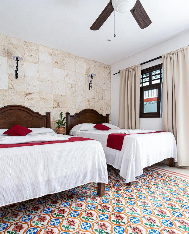 Postel nebo postele na pokoji v ubytování La Aurora Hotel Colonial