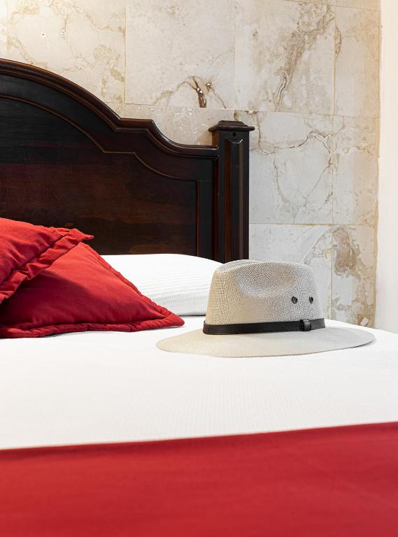 Postel nebo postele na pokoji v ubytování La Aurora Hotel Colonial