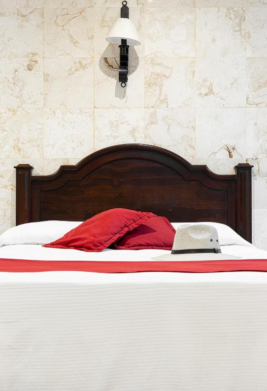 Postel nebo postele na pokoji v ubytování La Aurora Hotel Colonial