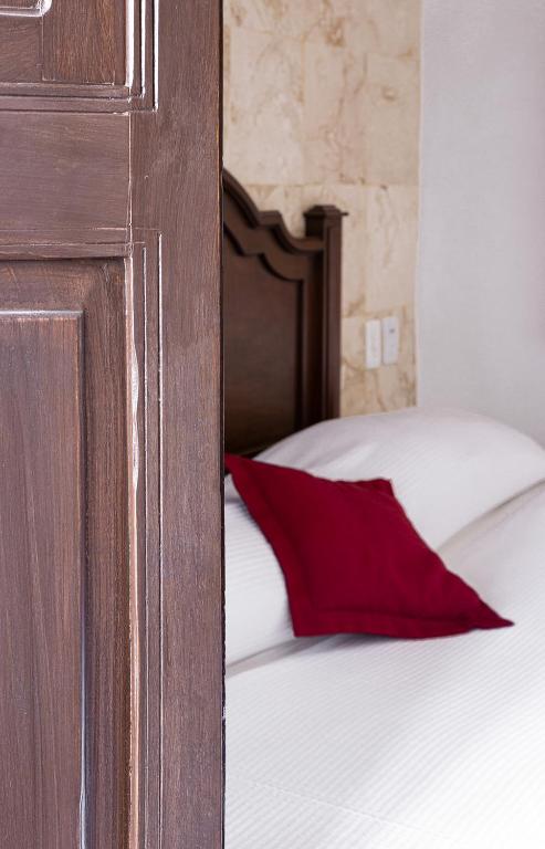 Postel nebo postele na pokoji v ubytování La Aurora Hotel Colonial