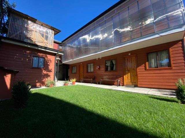 a large house with a lawn in front of it at Depto N°4 Temuco Centro in Temuco