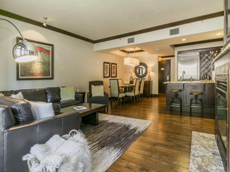 a living room with a couch and a kitchen at Luxurious 3 Bedroom With Ski in & out Access condo in Truckee