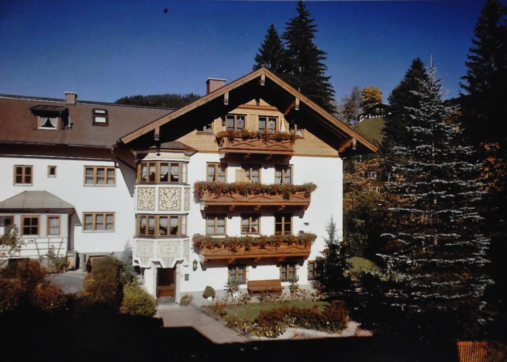 a large white building with balconies and plants on it at Haus Wagrain in Wagrain