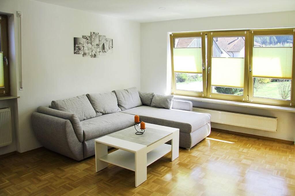 a living room with a couch and a coffee table at Schöne helle Ferienwohnung in Waldnähe in Berching