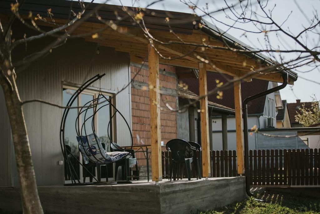 un porche cubierto con dos sillas en Anchor home, en Brčko