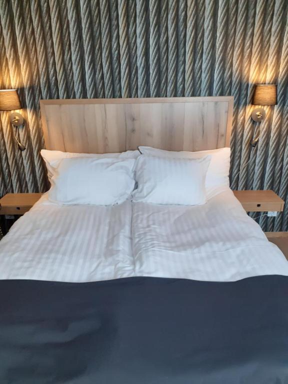 Postel nebo postele na pokoji v ubytování Hotell Greven