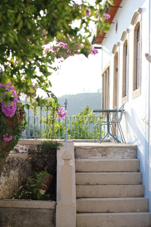 a staircase leading up to a building with pink flowers at The Little Olive Quinta in Alvaiázere