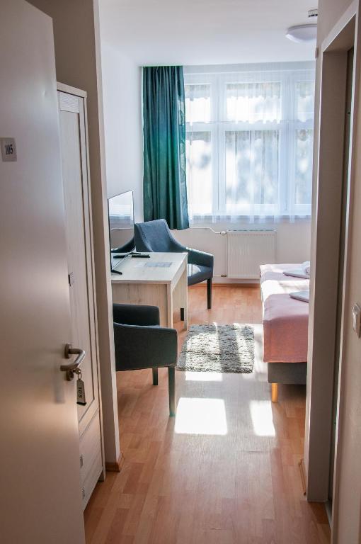 Posteľ alebo postele v izbe v ubytovaní Harangtorony Szálló