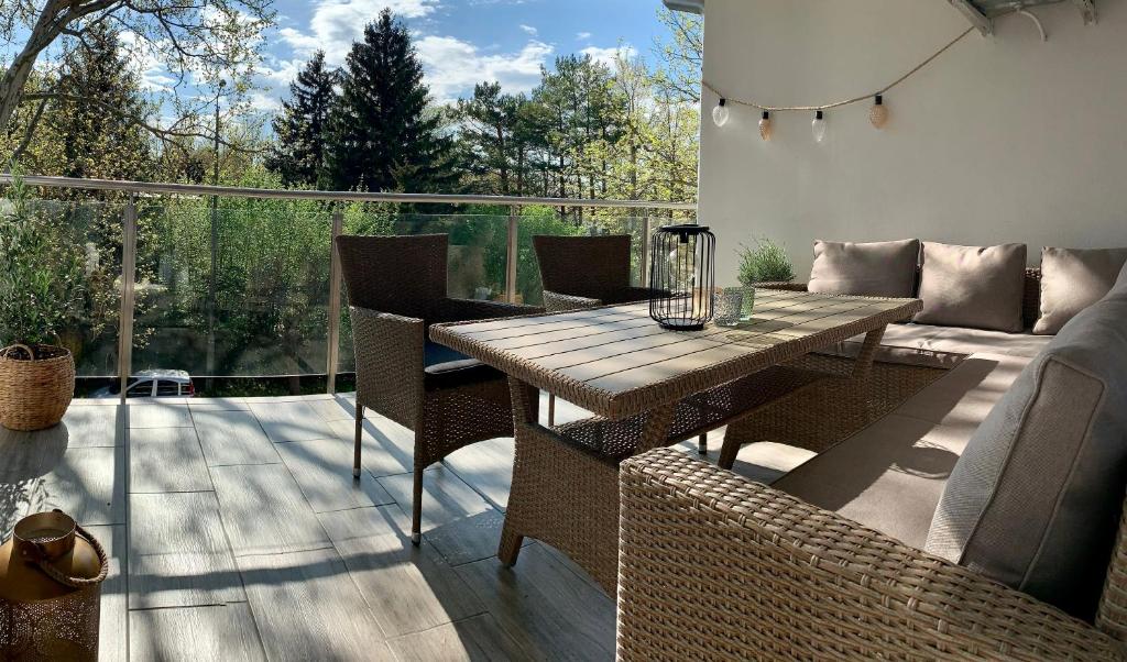 a patio with a table and chairs on a deck at South Part Zamárdi in Zamárdi