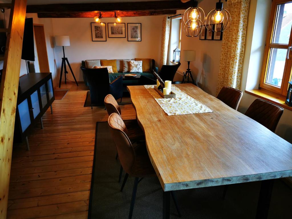 a dining room with a wooden table and chairs at "Eiche" in Ilsenburg